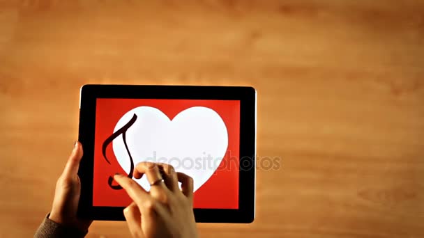Та амо каллиграфия. Женщина пишет в белом сердце на планшете — стоковое видео