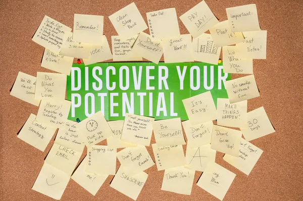 A lot of stickers for notes with text and banner discover your potential on a cork board