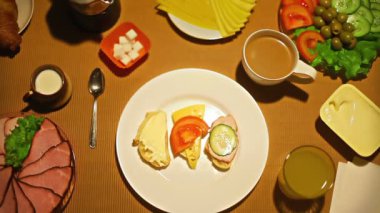 Kahvaltıda meyve suyu bir bardak alarak üstten görünüm eller