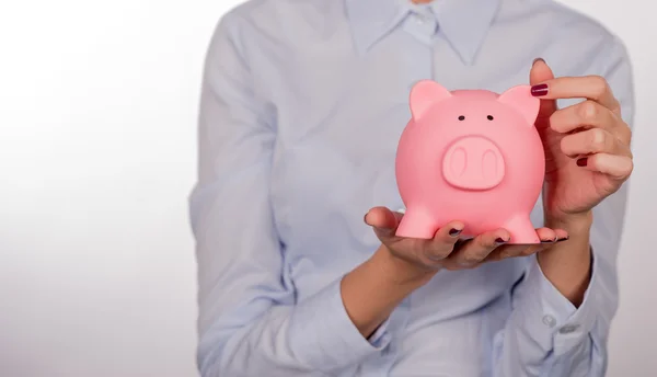 Piggy bank savings woman smiling happy. Female holding piggy bank isolated on white background. — Stock Photo, Image