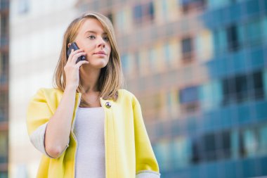 iş, teknoloji ve insan kavramı - ofis binası üzerinde konuşmak smartphone ile ciddi iş kadını