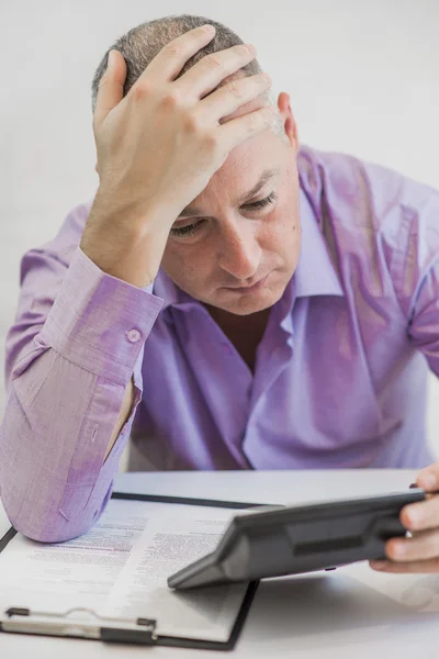 Hombre preocupado calculando el impuesto sobre fondo blanco — Foto de Stock