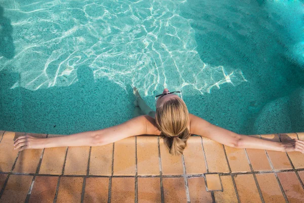 Spa vacation retreat woman relaxing at luxury travel resort. Hapy blissful young woman in bikini in meditation enjoying summer sun and tanning during holidays.