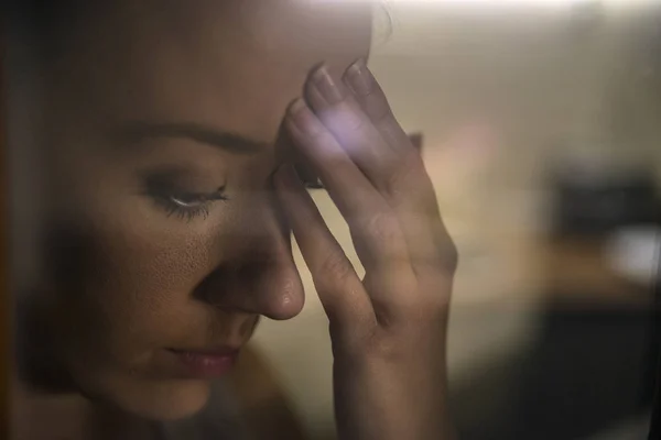 Hermosa chica triste y solitaria sentada cerca de la ventana falta —  Fotos de Stock