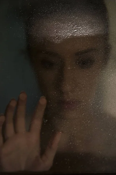Fiatal nő szomorú és szomorú az ablakon az eső keze — Stock Fotó