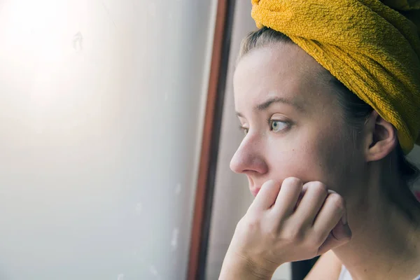Lonely girl near window thinking about something. Melancholy refreflection of the girl in the window — Stock Photo, Image