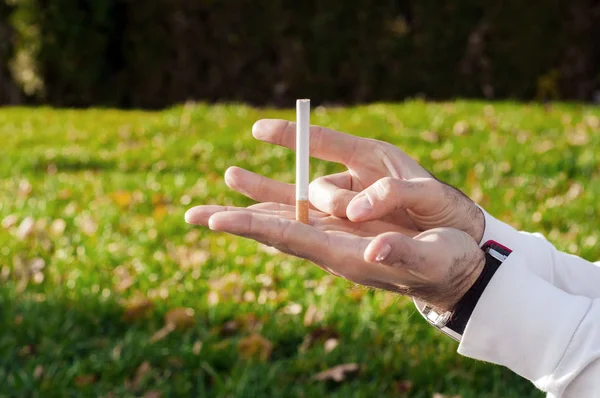 Gesture for quit smoking, Anti Smoking,  male hand crushing cigarette, Non Smoker. man has decided to stop smoking.