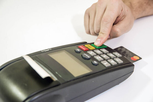 Payment with credit card - businessman holding pos terminal. hand pin code on pin pad of card machine or pos terminal 