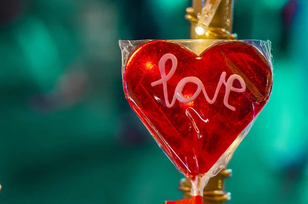 heart red shaped lollipop, valentine heart, valentine day. Christmas decorations - heart shaped lollipop, over bright blurred golden bokeh background.