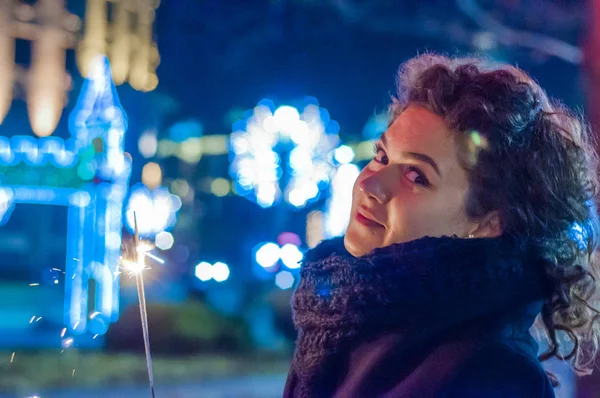 Acercamiento de la mujer sosteniendo chispa en la noche. Feliz Año Nuevo — Foto de Stock