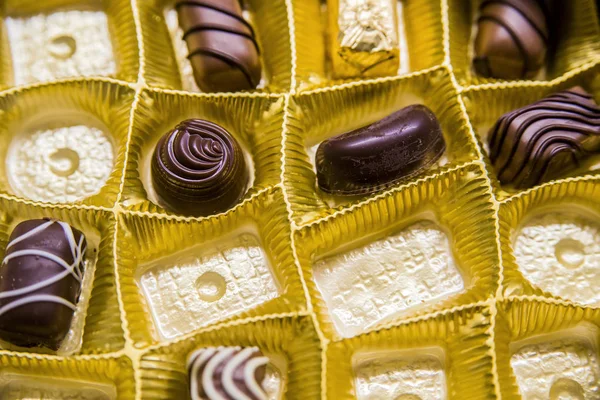 A box of chocolates partially empty viewed from above. Box of chocolate truffles, close-up, from above - colorful selection of chocolate, chocolate gift