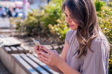 Güzel casual kadın manifatura onun cep telefonu. Ona telefon ile gülümseyen güzel kadın manifatura portresi