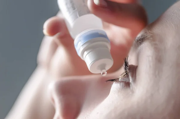 Young woman applying eye drop — Stock Photo, Image