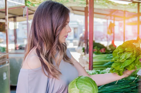 Girl in casual clothing holding cabbage — Stock Photo, Image