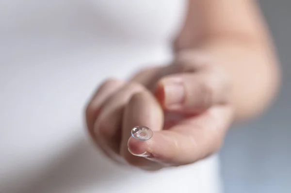 Young woman with contact lens