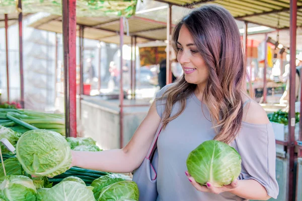 woman choosing fresh vegetables