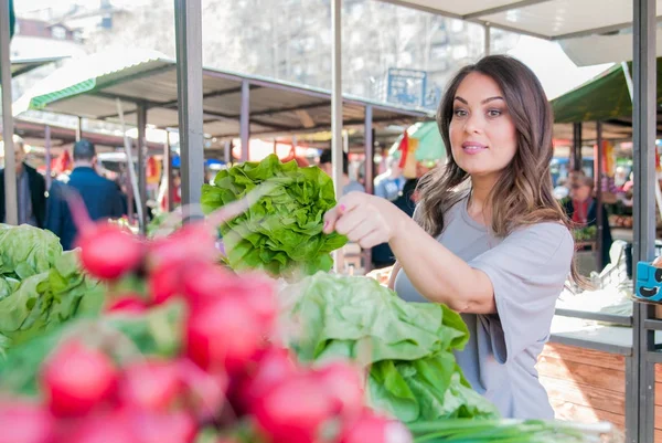 woman choosing fresh vegetables