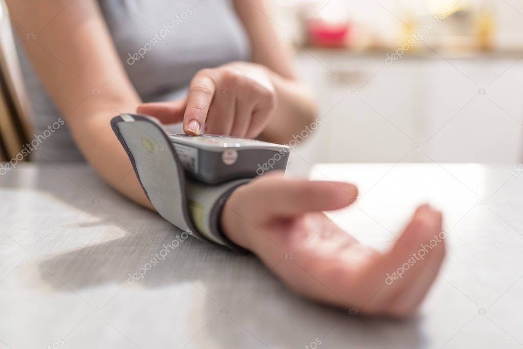 woman measuring blood pressure