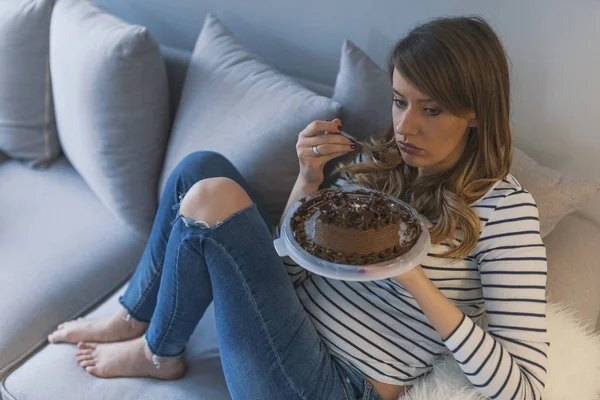 Depressed woman eats cake.  Sad unhappy woman eating cake. Sad woman eating sweet cake. Close up of woman eating chocolate cake. food, junk-food, culinary, baking and holidays concept