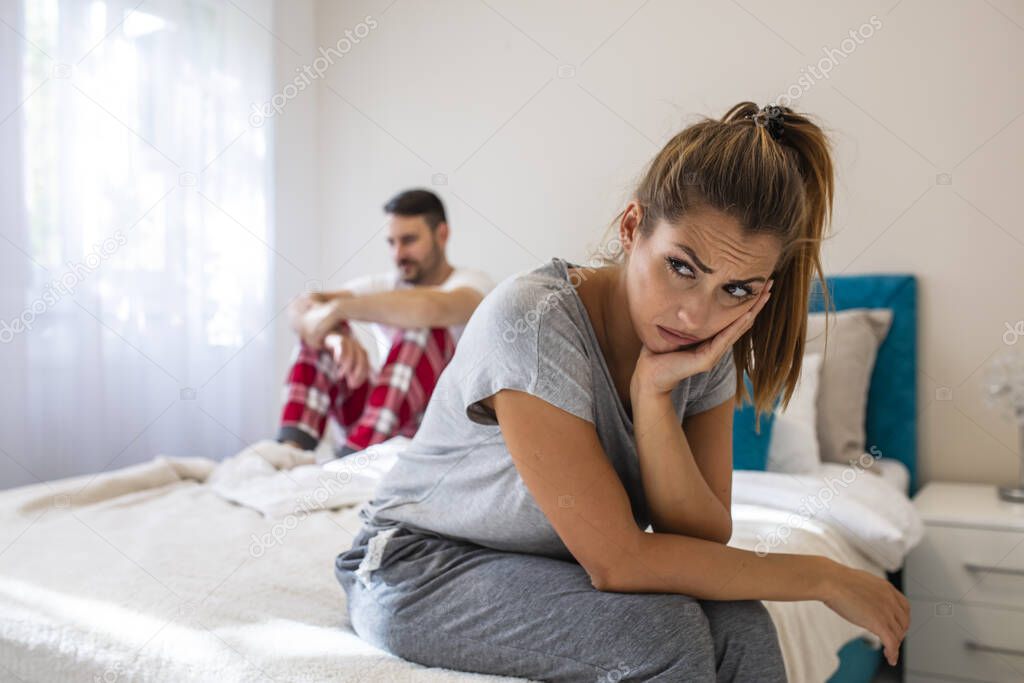 Couple having relationship problems. Young couple having relationship difficulties. Picture showing young woman and her man having problem in bedroom. We have a problem