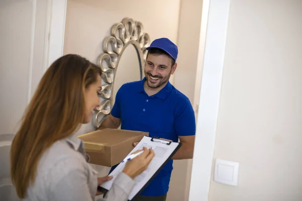 Woman Signing Package Courier Home Smiling Young Delivery Man Holding — 스톡 사진