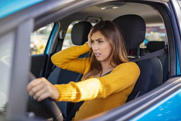 Nervous female driver sits at wheel, has worried expression as afraids to drive car by herself for first time. Frightened woman has car accident on road. People, driving, problems with transport