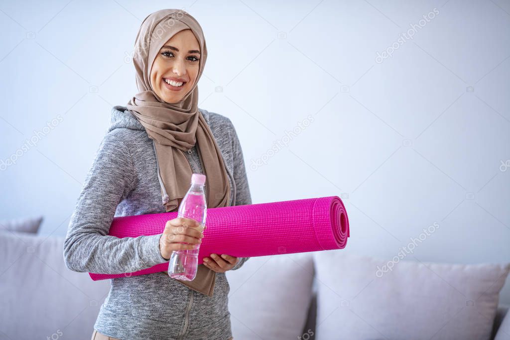 Islamic woman preparing for workout. Young muslim woman ready to running. Islamic woman resting and drinking water. Young muslim woman packing sports stuff for training