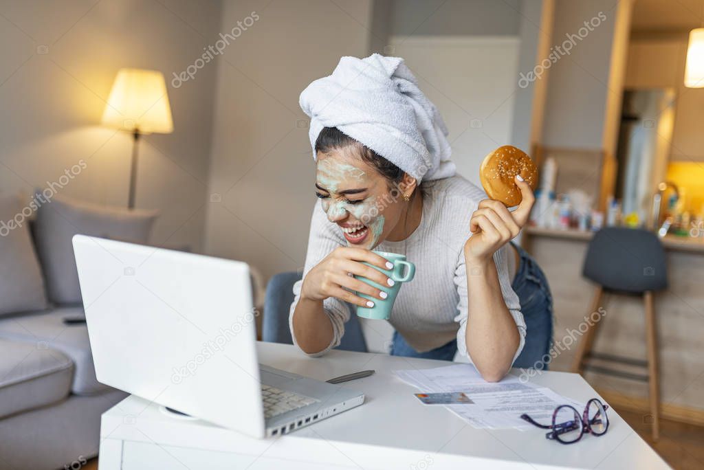Attractive young woman with face mask surfing the net from her home. Business, people and technology concept - happy smiling woman with laptop computer working at home 