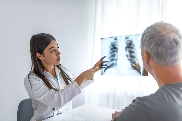 Kvinnlig Läkare Förklarar Kontrollresultat För Sin Patient Med Hjälp Röntgenbild — Stockfoto
