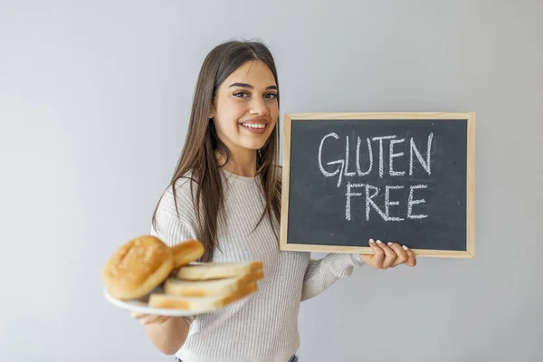 Gluten Free food Celiac Disease Nutrition , Healthy lifestyle concept with diet and fitness , Nutrition facts. Gluten intolerance concept. Woman holding board with gluten free sign and  bread