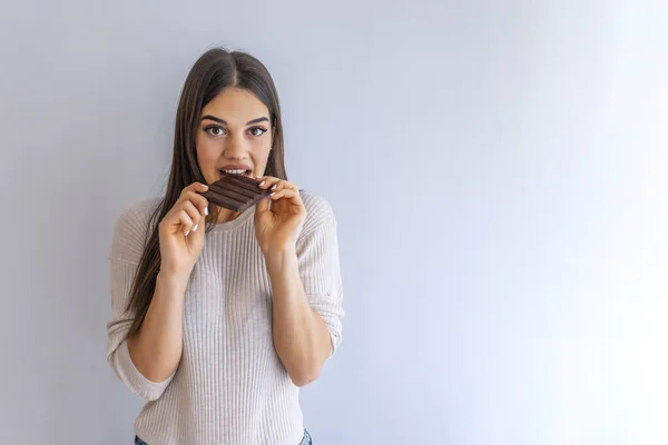 Portrait Satisfied Pretty Girl Biting Chocolate Bar Looking Camera Isolated — Stock Photo, Image