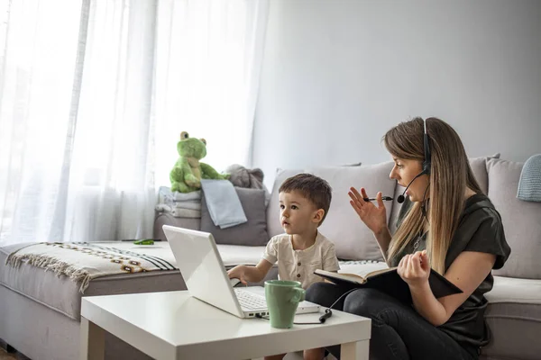 Mother working from home with kid. Children make noise and disturb woman at work. Homeschooling and freelance job. Moms Can Balance Work and Family. Multitasking mother working from home.