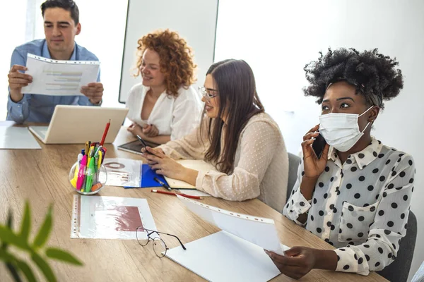 Corona Virus. Office workers with mask for corona virus. Business workers wear masks to protect and take care of their health. Talking before a meeting. Working from home.