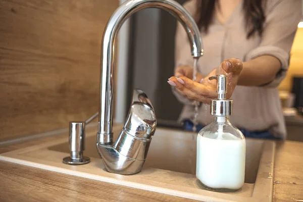 Woman Washing Her Hands. Hygiene concept. Washing hands with soap under the faucet with water. Woman washing hands indoors, closeup. Hygiene. Cleaning Hands.