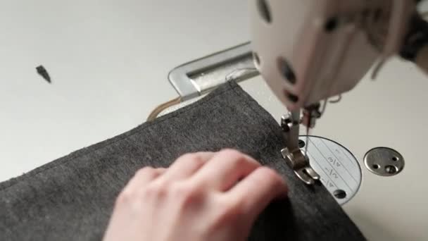 Close up of Woman s Hands Cutting a Thread and Sewing Two Pieces of Black Fabric Together — Stock Video