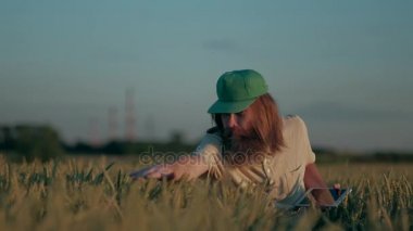 Yetişkin Hipster çiftçi bitkileri hasat denetler, fotoğraf çeker ve sonucu bir dijital Tablet üzerinde yazar