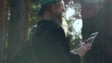 Açık havada dijital tabletli bir adam.