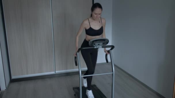 Çekici kız evde bir koşu bandı üzerinde çalışan — Stok video