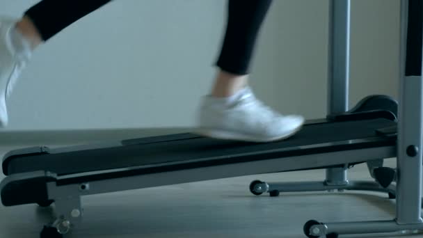 Female foots running on treadmill at home — Stock Video