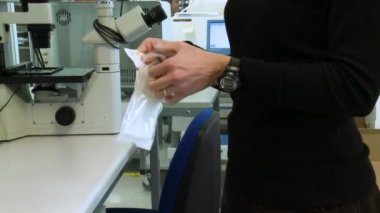 Müfettişler şırıngayı açıp laboratuardaki bir masaya koyarlar..
