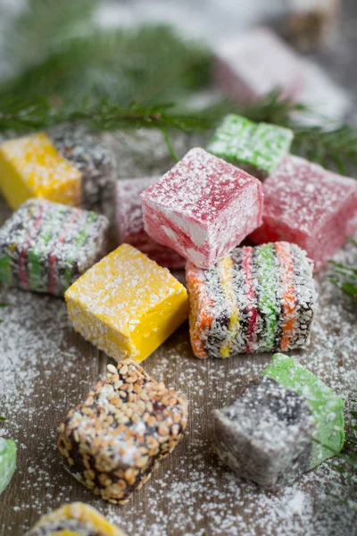 Christmas sweets on a wooden background decorated Christmas tree.