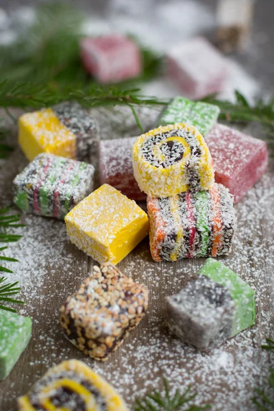 Christmas sweets on a wooden background decorated Christmas tree.