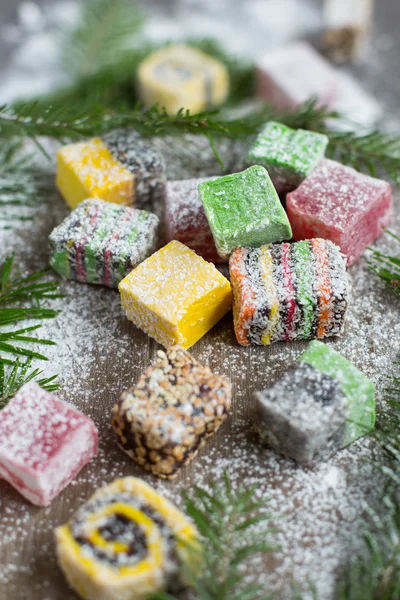 Christmas sweets on a wooden background decorated Christmas tree.