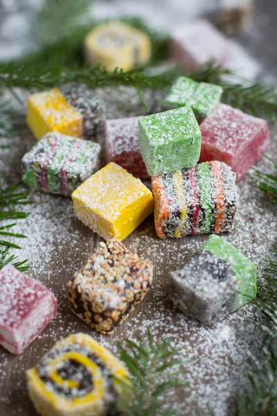 Christmas sweets on a wooden background decorated Christmas tree.