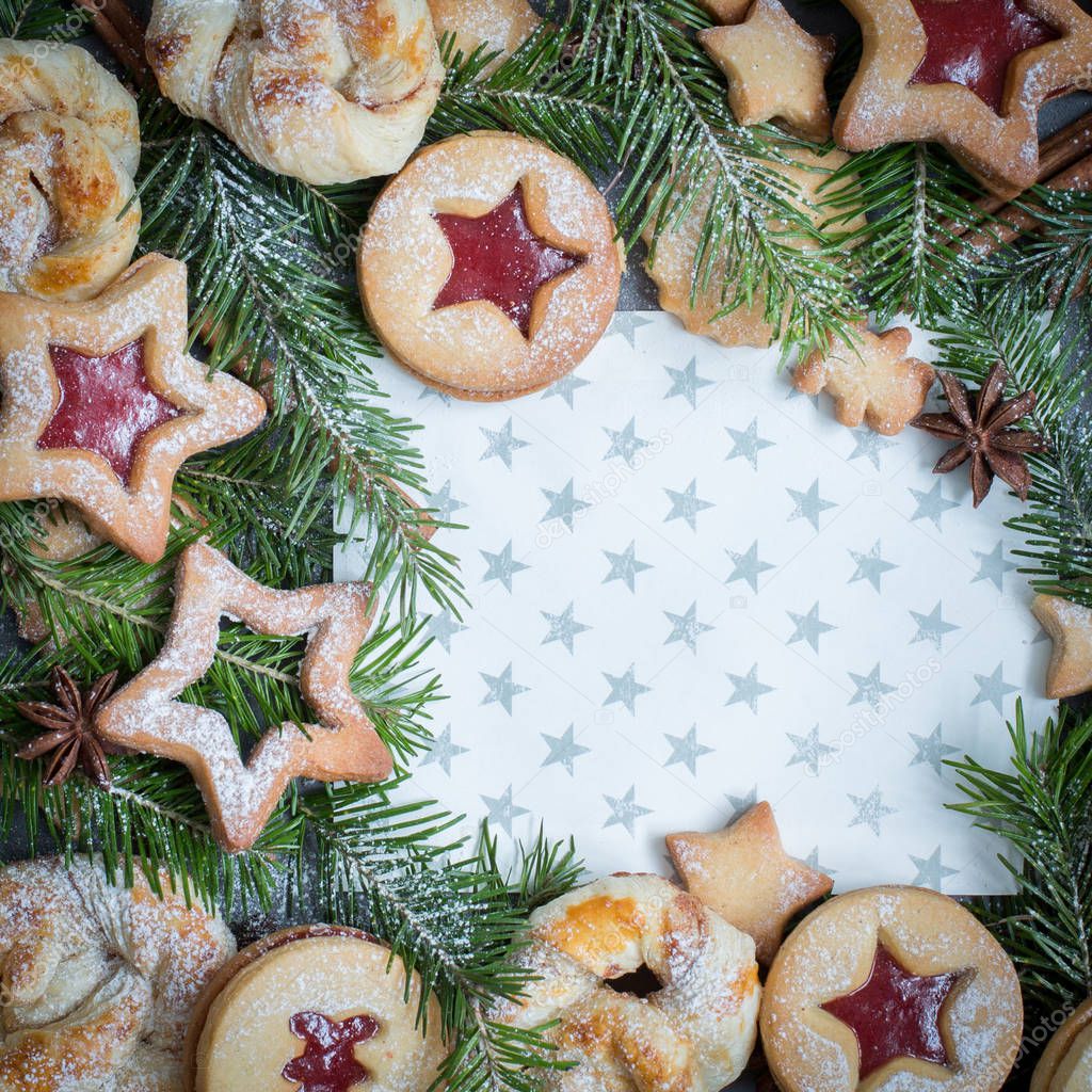 Ginger homemade cookies - stars with strawberry jam on paper gray background