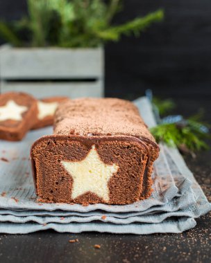 Bir çok çikolatalı kek ile koyu çikolata kaplı ve bir vanilya ile kakao serpilir içinde yıldız. Ahşap koyu arka plan üzerinde. Taze kızılcık, mükemmel serin Noel tatlısı ile dekore edilmiş