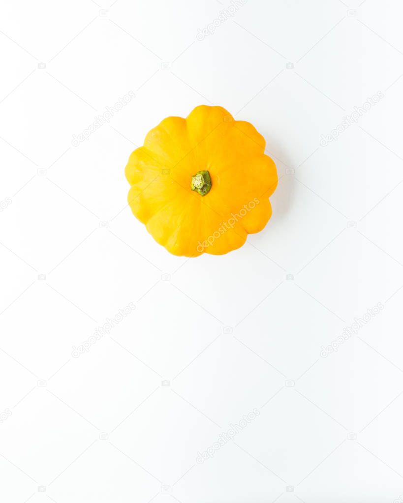 Creative layout (pattern) made of small yellow pumpkins. Flat lay. Food concept. Vegetables isolated on white background. Vegetables abstract background