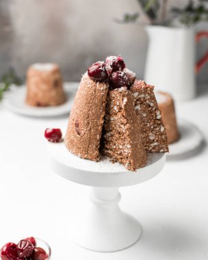 Kiraz ve süzme peynir, çikolata mini ham kek kiraz ve Hindistan cevizi ile dekore edilmiştir. Geleneksel Rus Paskalya tatlı. Işık Beyaz ahşap zemin üzerinde. Çocuk oyuncağı.