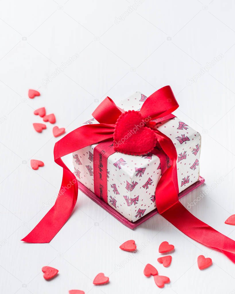 Gift box with red ribbon and sweet candy hearts on black concrete background.Beautiful Valentines day.Romantic mood.) 
