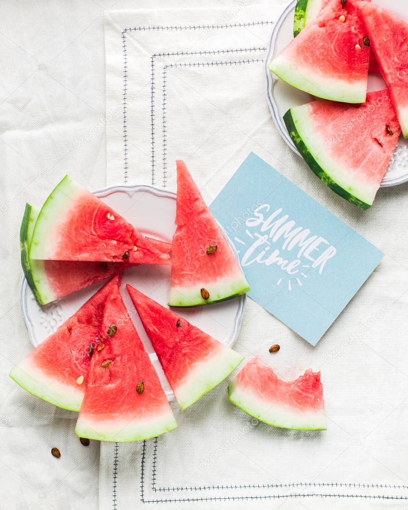 Summer time! Slices of fresh juicy red watermelon on a light white background Place for text. Flat lay, top view